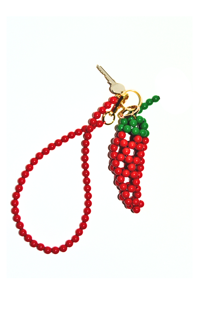 Red beaded charm shaped like a chili pepper with a keychain on a white background