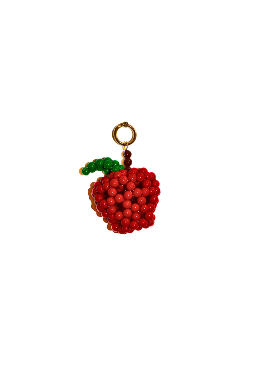 Red beaded apple charm with a gold stem on a white background