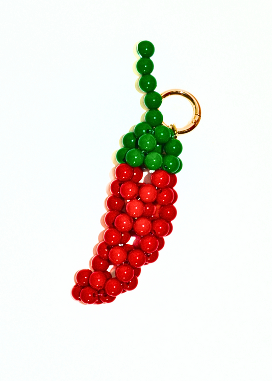 Keychain shaped like a chili pepper with green and red beads on a white background