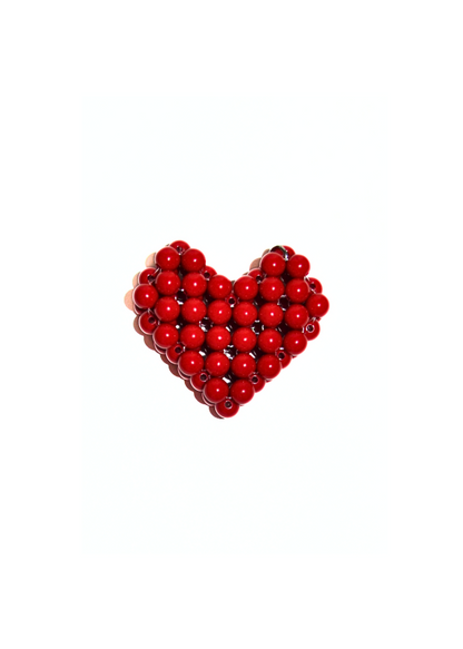 Red heart-shaped object made of small beads on a white background